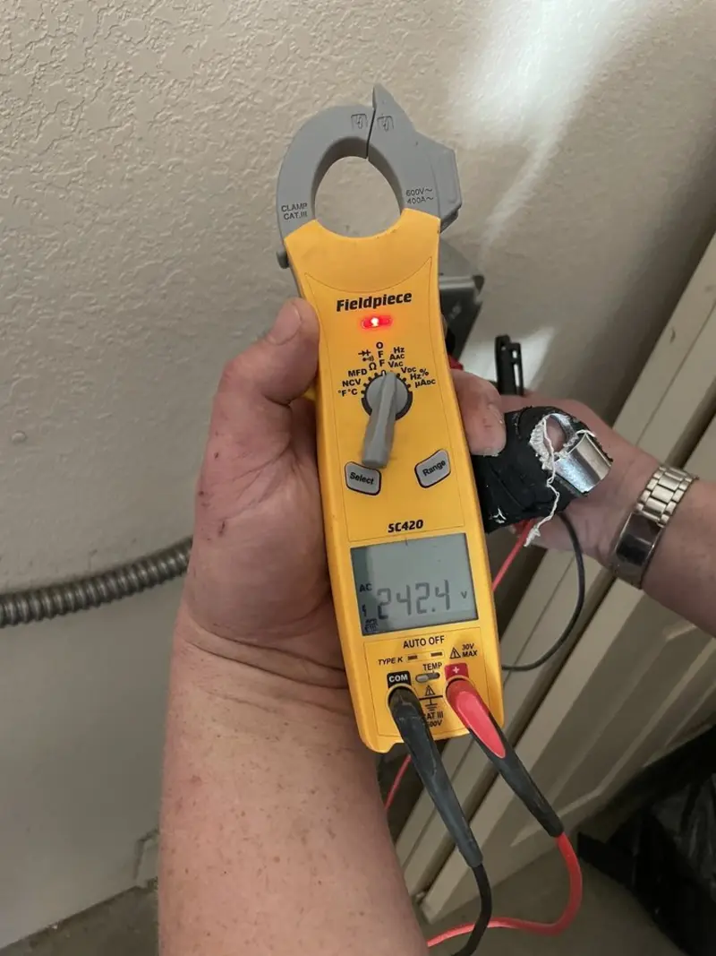 Voltage testing with clamp meter during Ceiling Fan Installation in Ridley